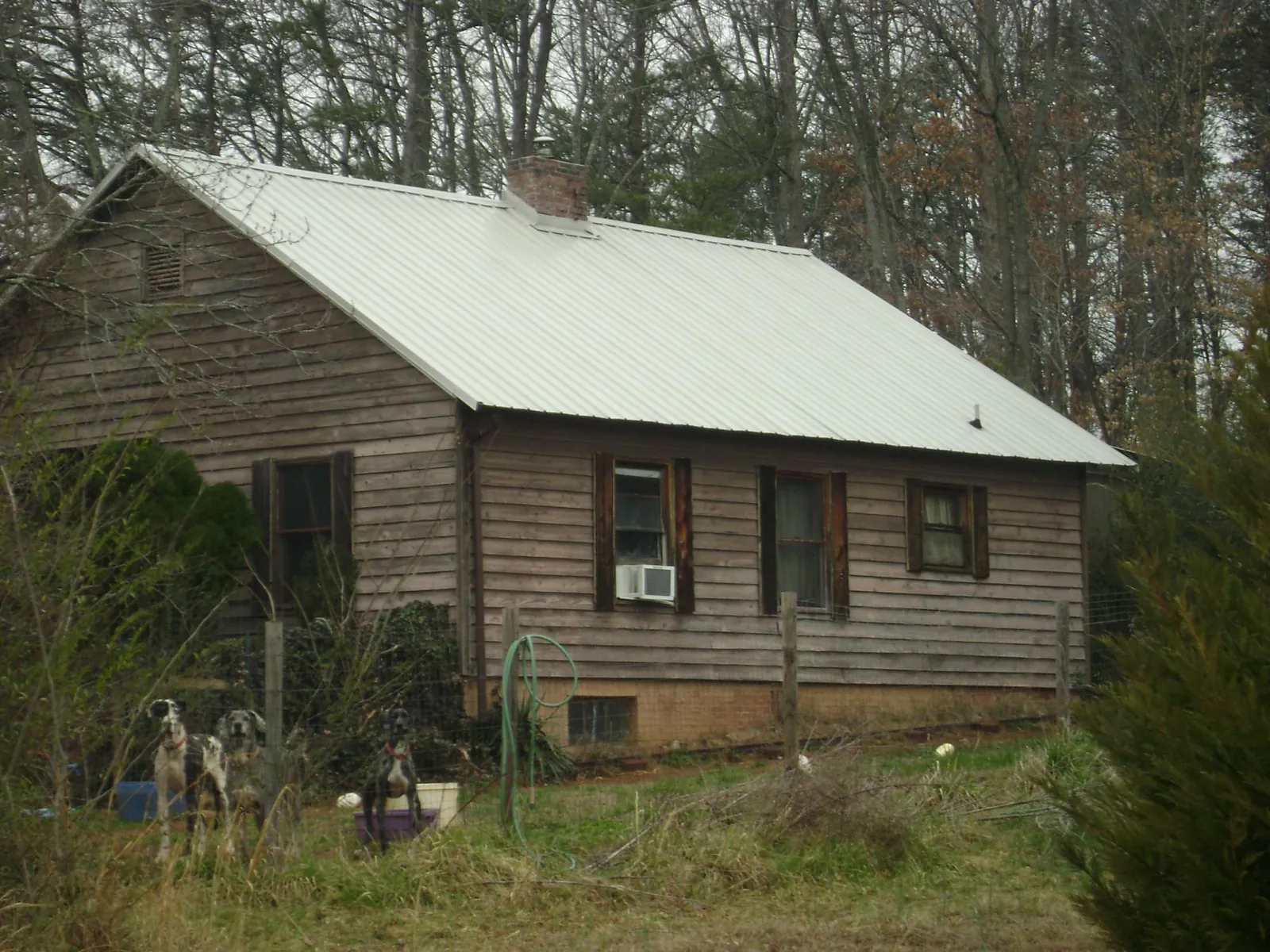White metal roof on an old wood sided farmhouse, from a Asphalt Shingle Roof Repair job in Manchester